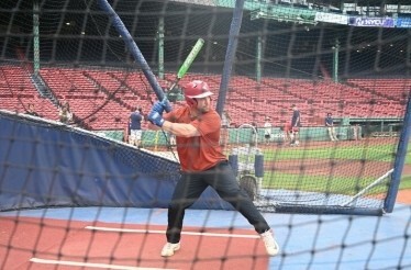 A Red Sox™ player playing baseball at Fenway Park™.